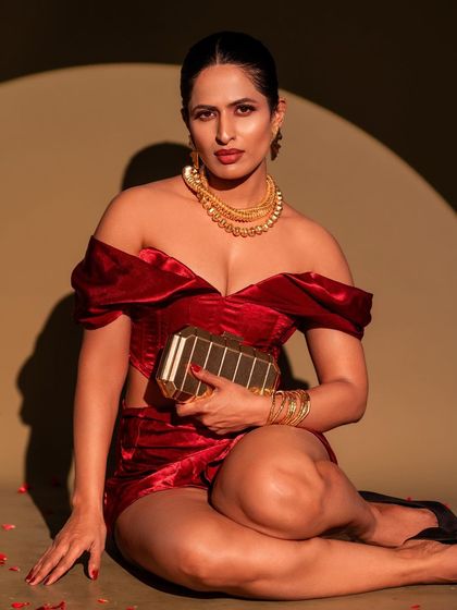 A bold and confident look for a modern event. This portrait features a custom red velvet co-ord set, paired with statement gold jewellery for a high-fashion feel.