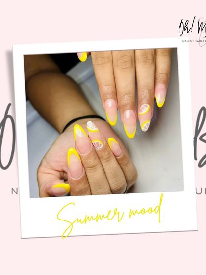 Nothing screams summer like a pop of yellow. This design features a bright yellow French tip with a fun, hand-painted lemon slice accent nail.