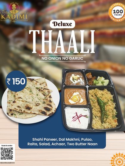 A closer look at our Deluxe Thali. This no onion no garlic meal includes Shahi Paneer, Dal Makhni, Pulao, Raita, Salad, Achaar, and two Butter Naans, providing a complete and flavorful experience.