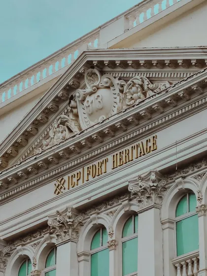A close-up of the intricate carvings on a heritage building in Fort, showcasing the incredible craftsmanship of a bygone era.