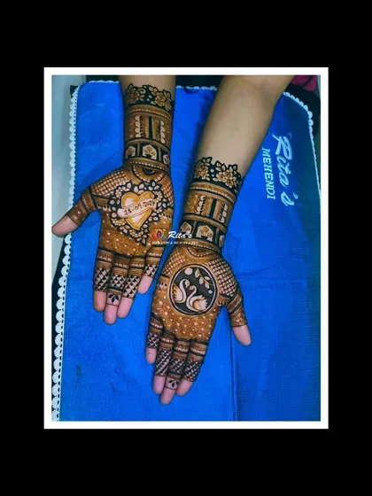 The full two-hand design, with the engagement date on one palm and a pair of graceful swans on the other.