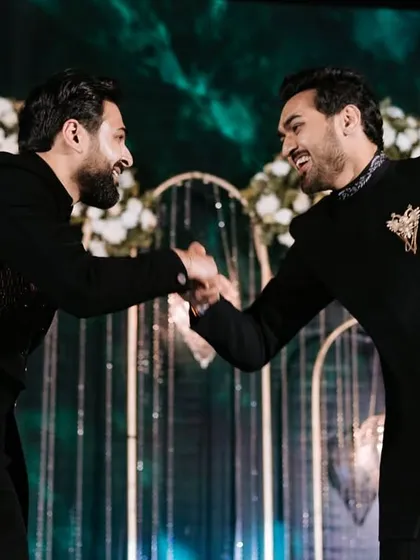 A moment of camaraderie between two brothers or friends during their performance.