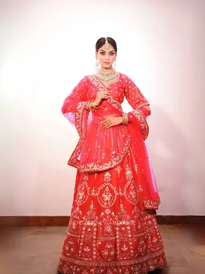 A full-length shot showcasing the grandeur of this pink bridal lehenga. It’s an ideal choice for makeup artists wanting to feature traditional wedding looks.