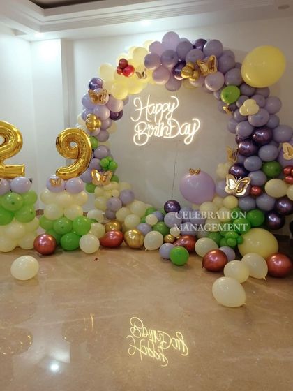 Another view of the colorful 29th birthday balloon arch, showing the reflection on the glossy floor which adds to the overall festive look of the room.