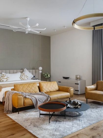 A spacious master bedroom includes its own seating area with comfortable leather sofas, creating a private suite for relaxation.