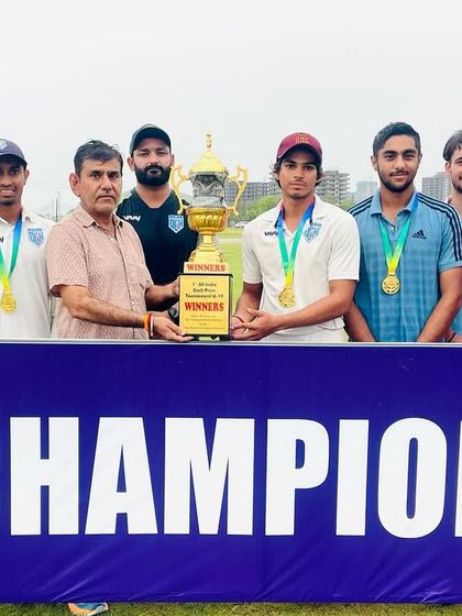 The team receiving the winner's trophy. A proud moment for Delhi Cricket Hub.