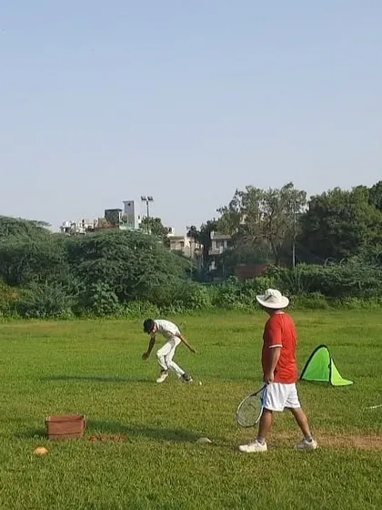 A coach oversees a fielding drill at our D I Khan ground. We use a variety of equipment like cones, hurdles, and ramps to simulate unpredictable ball movements and improve player reflexes.