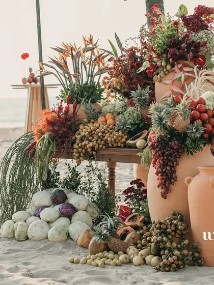 An abundant tropical fruit and floral installation for a sundowner event in Goa. This design blends the natural beauty of the beach with an overflowing display of local produce, creating a sensory feast for guests right on the sand.