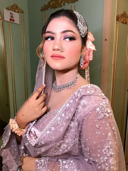 A close-up of the pastel look, showing the beautiful silver passa and the fresh roses in her hair.