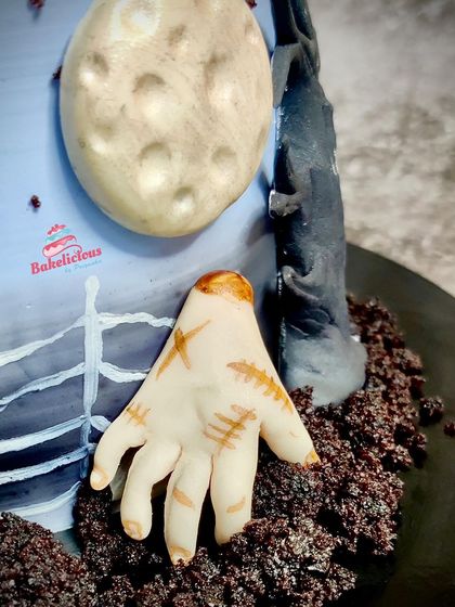 It's all in the details! Here's a close look at the creepy "Thing" hand crawling out of the chocolate "dirt" on the Wednesday cake.