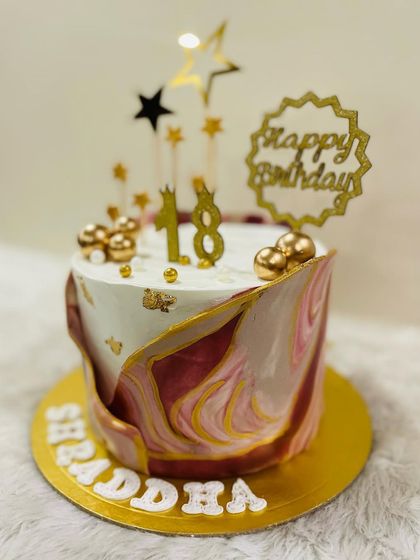 A chic and modern cake to celebrate an 18th birthday. This design features a beautiful maroon and gold marble effect, topped with stars for a touch of glamour.