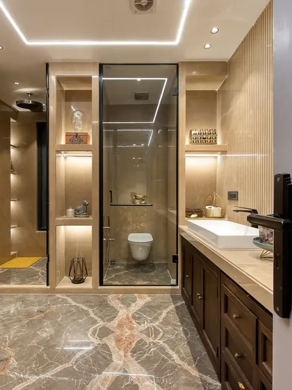 A view into the bathroom from the doorway, showing the seamless integration of the wardrobe, vanity, and shower areas.