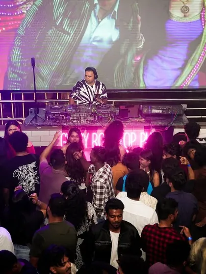 My VDJ setup in full swing at Gypsy Tower Rooftop. I don't just play music; I perform with visuals, mixing music videos and graphics live on the big screen to create a completely immersive audio-visual experience for the club.