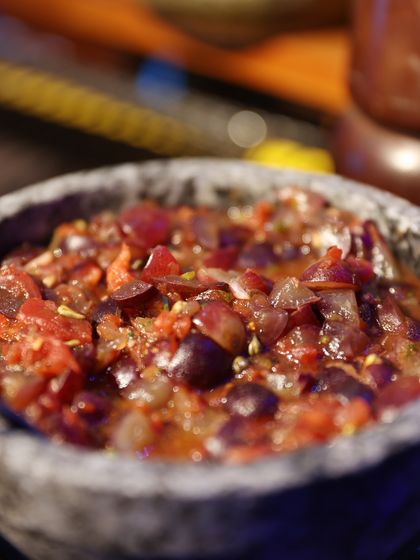 A close-up of our unique grape salsa, showcasing the fresh ingredients and textures that make our food so memorable.