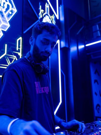 A close-up shot under the blue lights, focused on the mix.