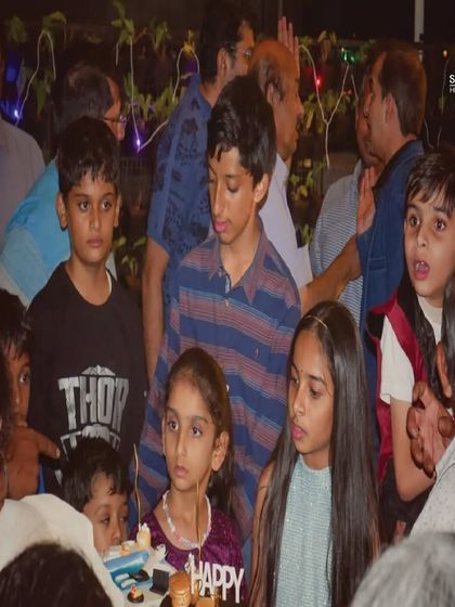 The kids gathered around for the birthday cake. Their excited faces say it all.