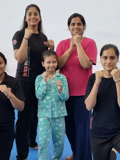 A group of our female trainees with a young girl, showing that empowerment starts at any age.