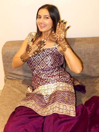 Pure happiness. The groom's sister can't hide her excitement over her stunning party henna.