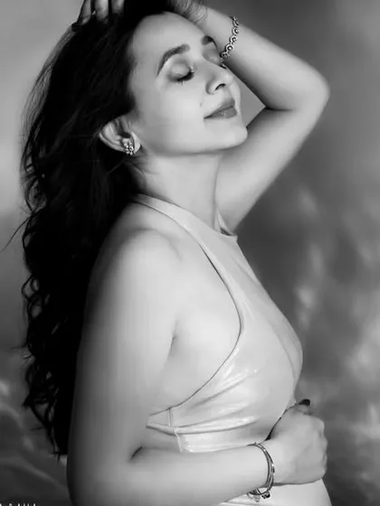 A close-up black and white portrait filled with serene emotion. The soft focus and gentle light create a dreamy and timeless feel.