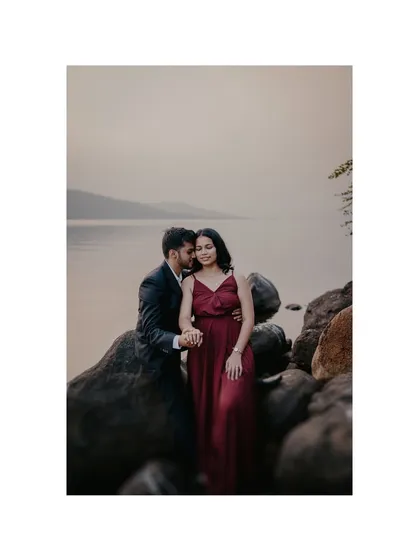A beautifully framed shot that feels incredibly intimate. The groom whispering to the bride creates a private, romantic moment that the viewer gets a glimpse of.