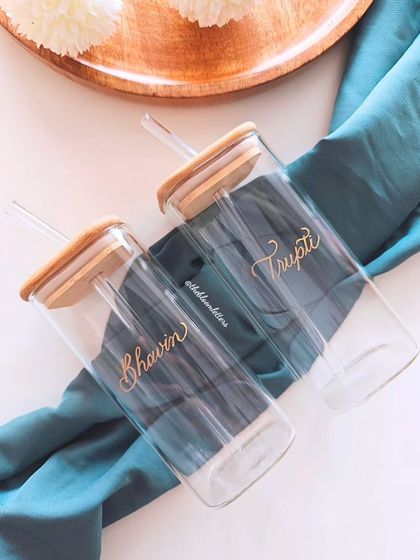 Elevating everyday essentials with a touch of personalized elegance. These glass juice jars with bamboo lids are engraved with the names 'Bhavin' and 'Trupti', making their daily routine a little more special.