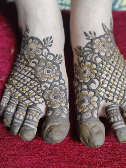 Your feet deserve beautiful henna too. This is a classic foot mehndi design, covering the top of the feet with an intricate floral and mesh pattern. It's a perfect choice for brides or for any festival where you want to feel decorated from head to toe.