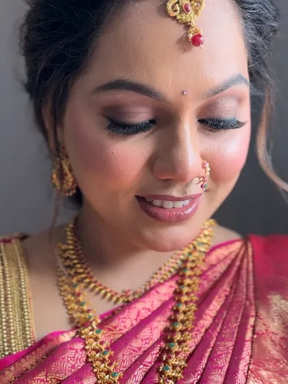 A subtle yet glamorous wedding look for this beautiful bride. The makeup is designed to enhance her features and complement her pink South Indian silk saree.