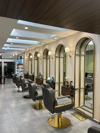 For the Madonna Salon in New Delhi, we designed a serene and elegant styling area. The repeating brass-framed arched mirrors and custom lighting create a rhythmic and sophisticated atmosphere, ensuring clients feel pampered and relaxed.