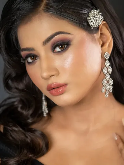 A close-up of the client's party look, showing the dramatic smokey eye and the sparkling hair clip. I love using accessories to elevate a simple wavy hairstyle.
