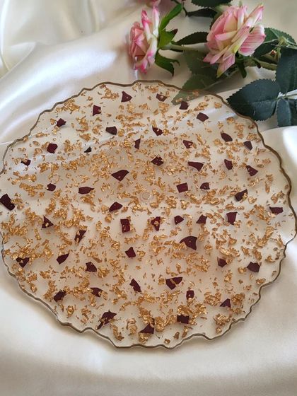 For a more abstract way to preserve your flowers, I can create a decorative tray like this one. This 10-inch piece features scattered red rose petals and gold flakes, perfect for an engagement ring platter or a beautiful centerpiece.