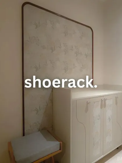 A well-designed shoe rack and seating bench for an entryway. The custom panel with a subtle pattern adds an artistic touch to a functional piece.