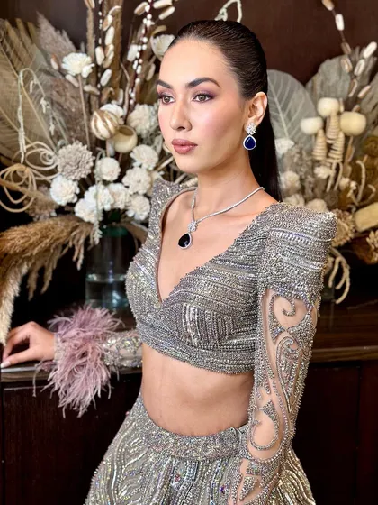 A high-fashion, luxury glam look with a sleek ponytail and dramatic eye makeup, perfect for a cocktail party.