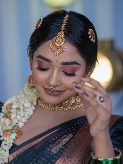 A close-up of the eye makeup, featuring soft pink and brown tones.