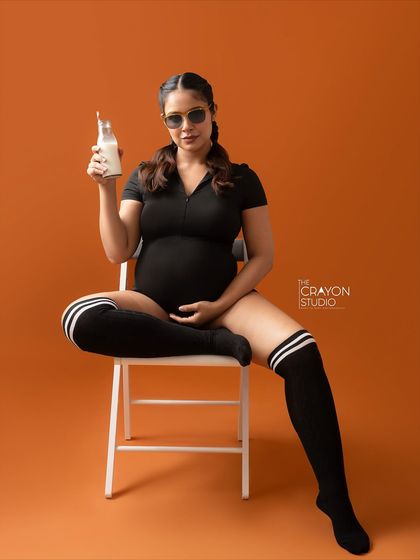 A full length view of the cool and confident mom to be during her sporty themed shoot. This shows how we can play with creative ideas in the studio.