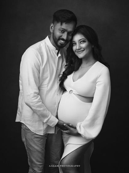 A classic couple's portrait in black and white, their matching white outfits creating a clean and modern look.