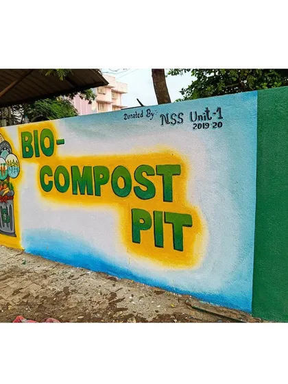 A side-angle view of the Bio-Compost Pit mural in Karwar. This perspective shows how the artwork transforms a simple functional wall into a point of interest and education for the college community.