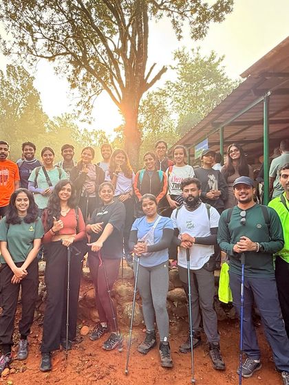 The team is all smiles at the start of the Kumara Parvatha trek. We provide trekking poles and guidance to make sure everyone is prepared for the journey ahead.