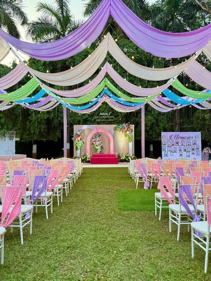 A wide view of the lawn, showing the full extent of the pastel draping and seating arrangement.