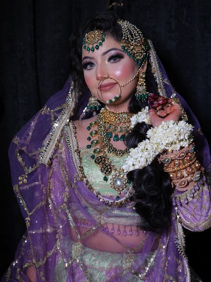 A final look at this magnificent ensemble. The combination of the purple dupatta, green blouse, and heavy jewellery creates a truly unforgettable bridal style.