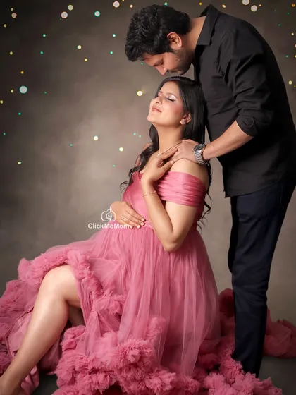 A romantic portrait celebrating your love story. Here, I used soft lighting and a sprinkle of magic to enhance the tender moment between the couple, with the mom-to-be seated in a beautiful pink tulle gown.