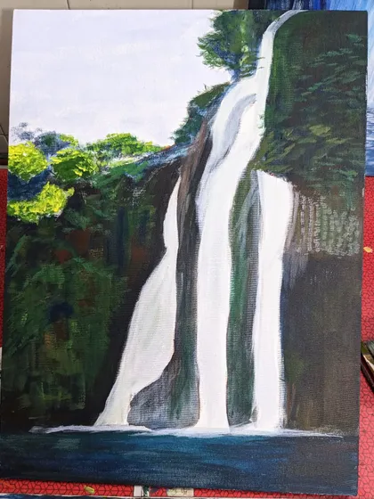 A work in progress shot of an acrylic waterfall painting. This shows the initial layers and blocking of colors before details are added.