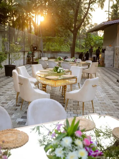 Golden hour at a birthday celebration I planned. The elegant mirrored tables and plush velvet chairs catch the sunlight beautifully, creating a warm and luxurious atmosphere for an intimate outdoor gathering.