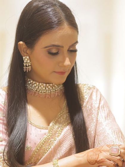 A close up of the engagement bride, showing the soft, shimmery eye makeup and the delicate jewelry.