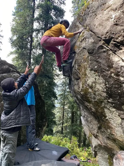 A climber navigates the "Walk in the Park" boulder in Sethan, with me providing a careful spot. Safety and support are always our top priorities during outdoor sessions.