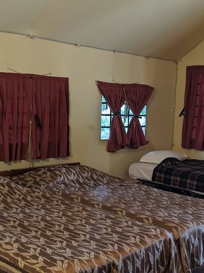 A spacious room in a tented cottage, perfect for families visiting the Kali Adventure Camp.
