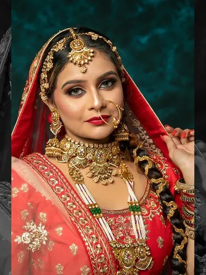A regal bridal look featuring a deep velvet lehenga. The makeup is dramatic and bold, with smokey eyes and a deep red lip.