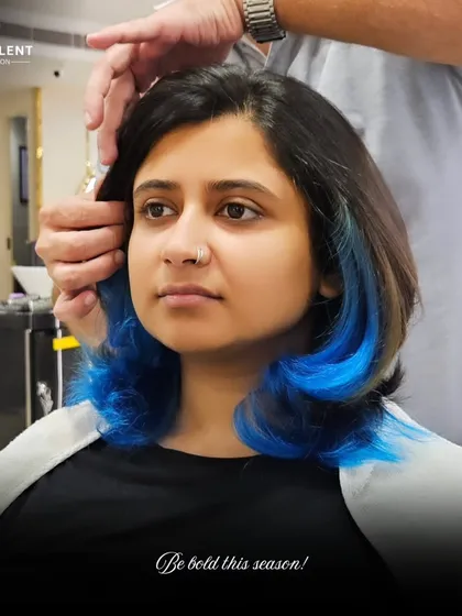 Don't be afraid to play with color. I added these electric blue peekaboo highlights to give this client's look a bold, edgy surprise. This technique is perfect for expressing your personality while maintaining a professional base color.
