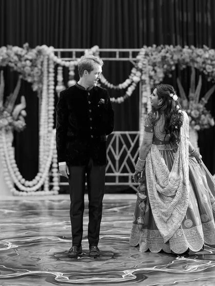 A quiet moment between the bride and groom on the dance floor before their performance. The black and white photo beautifully captures the anticipation and connection between them.