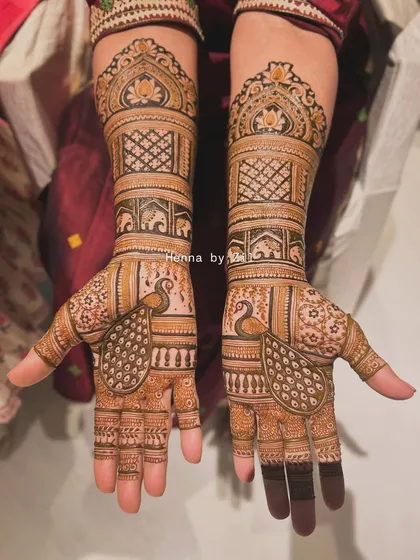 A traditional design featuring peacocks on the palms and elephants on the arms, with a beautiful symmetrical layout.