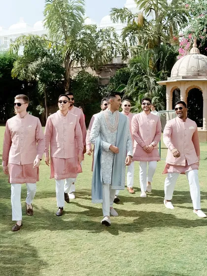 A wedding is also about the people standing with you. I coordinate outfits for the entire groom's party, ensuring the groomsmen's pink kurtas perfectly complemented the groom's bespoke sherwani without being overly matched.